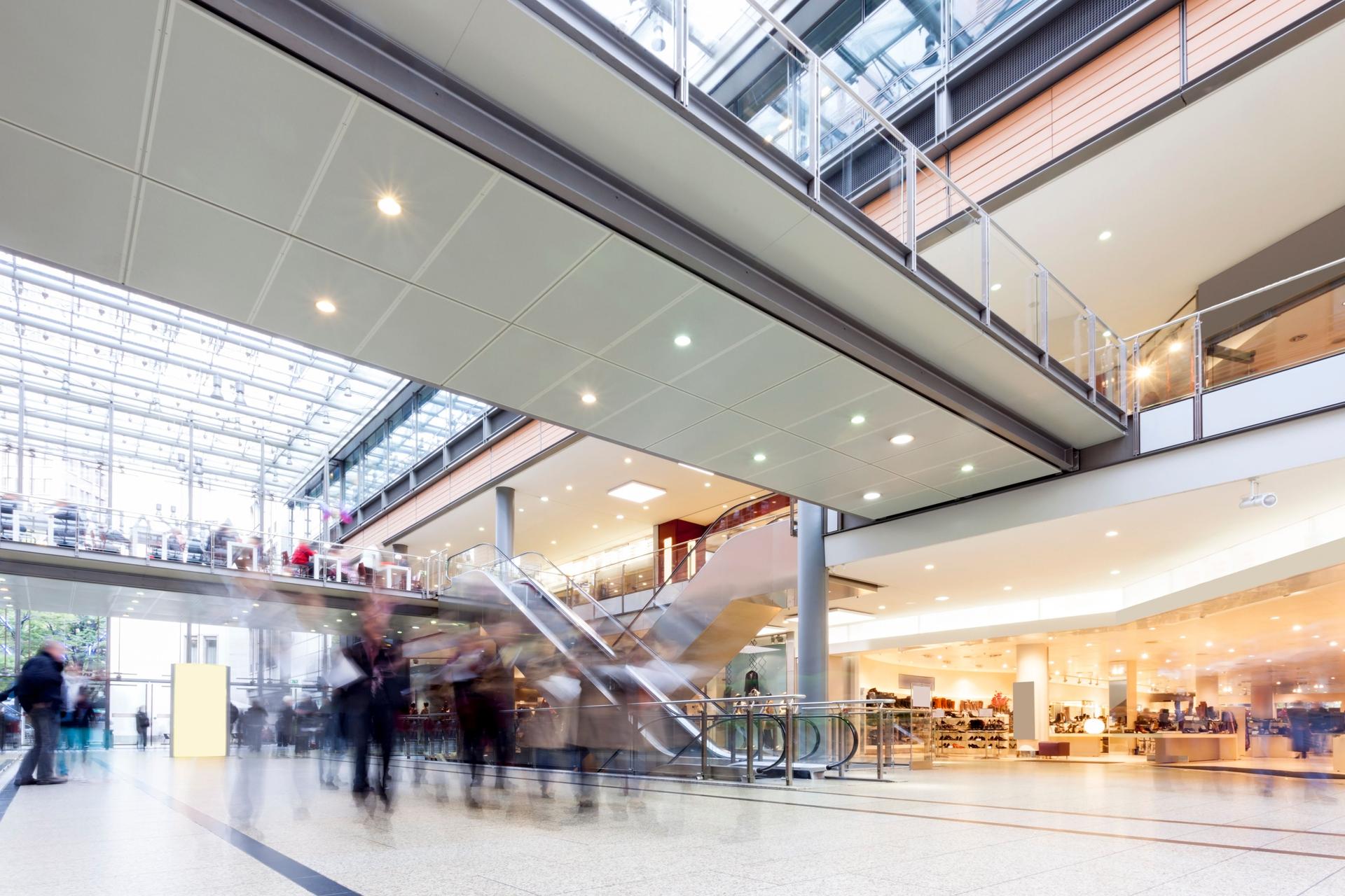 Modern Busy Shopping Mall with motion Blurred Shoppers