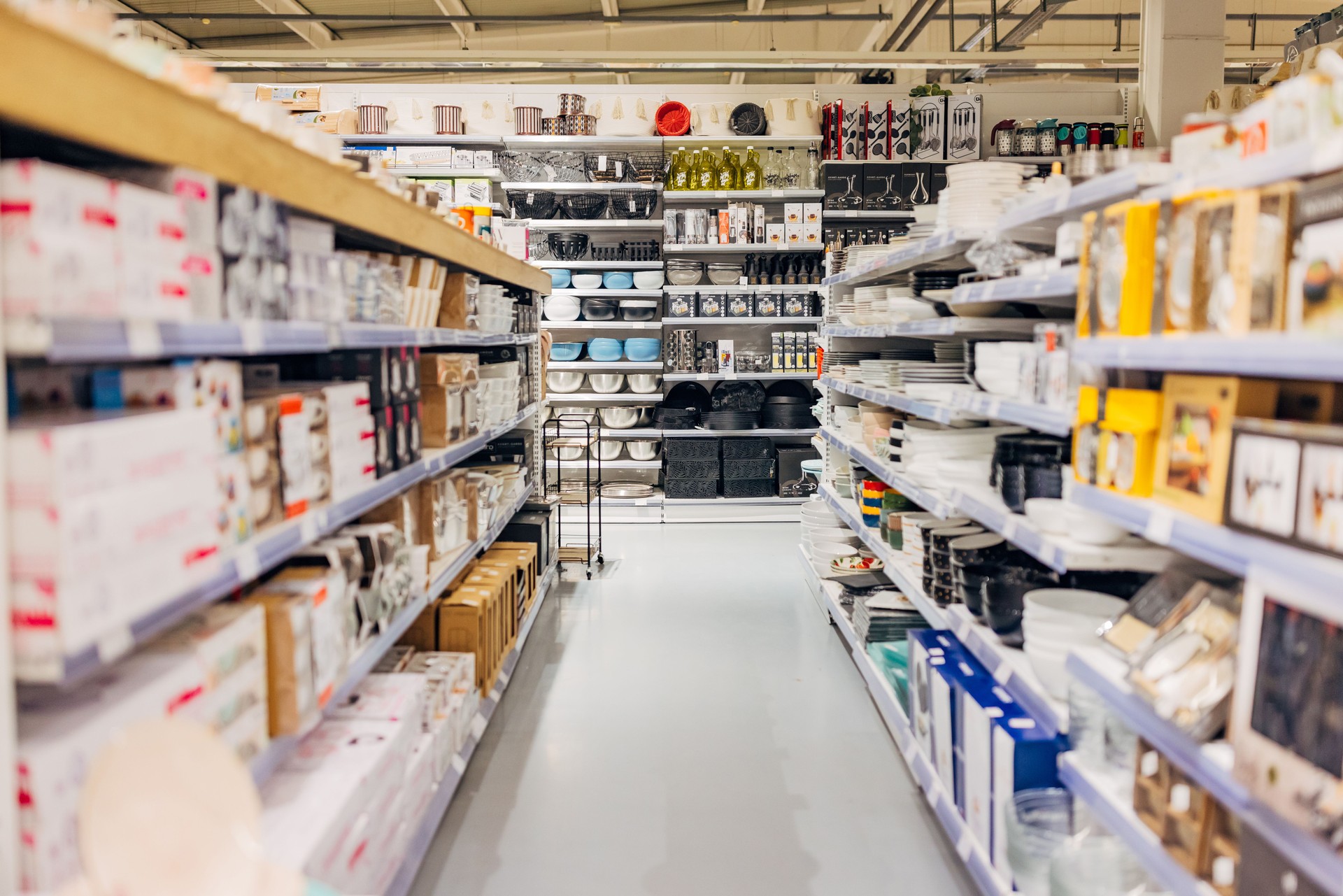 Full shelves in the store of household appliances and furniture, kitchen accessories